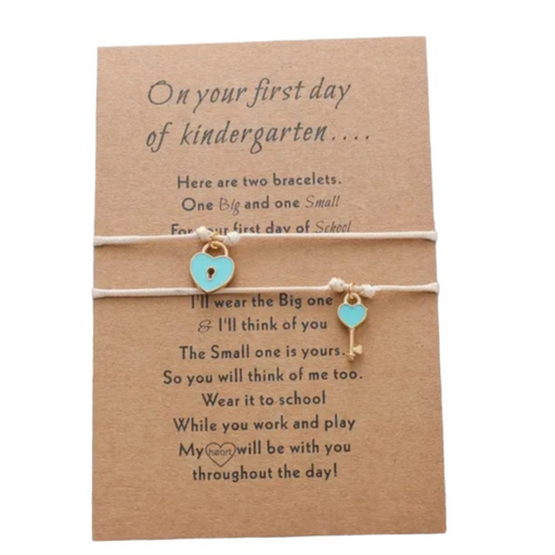 2 beige bracelets with a lock and key on a message card for first day of kindy
