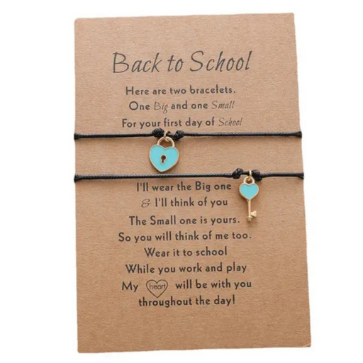 2 black bracelets with lock and key charms on a grey message card