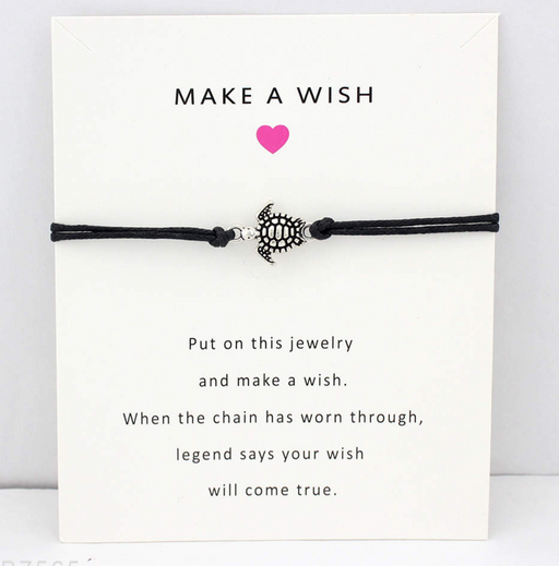 Black string bracelet with turtle charm on a friendship card