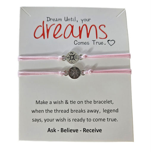 2 pink string bracelets with north south east and west charm.