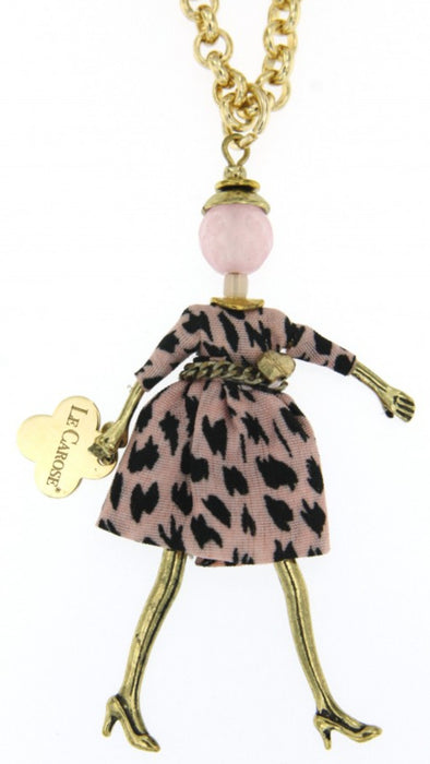 long gold chain necklace with carosina doll pendant wearing pink spotty dress