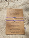 Purple bracelet set of 2 with heart charms on a sandy beach