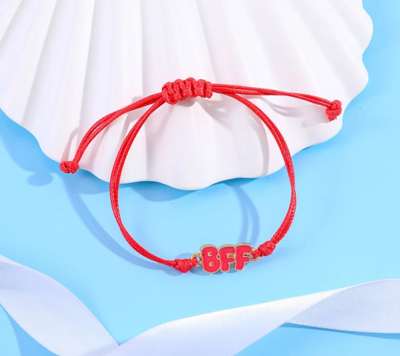 Red BFF bracelet on a table shell