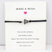 Black string bracelet with turtle charm on a friendship card