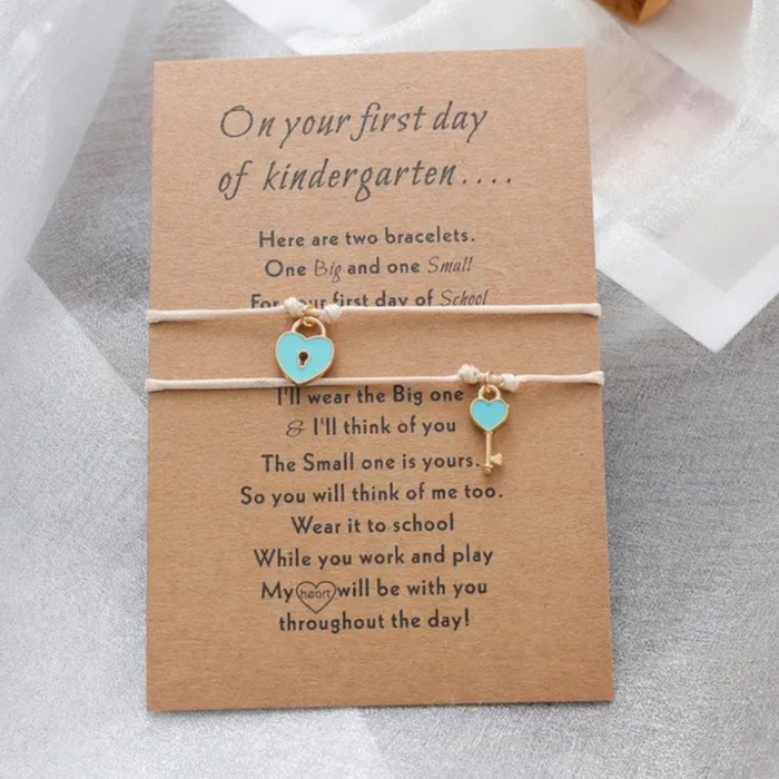2 beige bracelets with lock and key on message card 