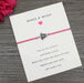 Pink turtle bracelet on a card on table