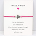 Pink string bracelet with turtle charm on a white message card