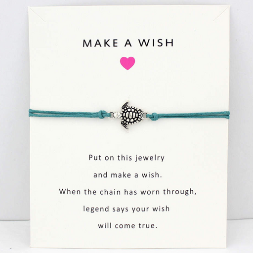 Turquoise bracelet with turtle charm on a white friendship card