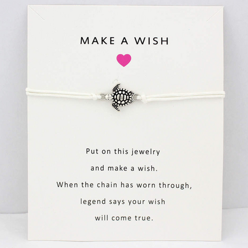 White string bracelet with turtle charm on a white message card