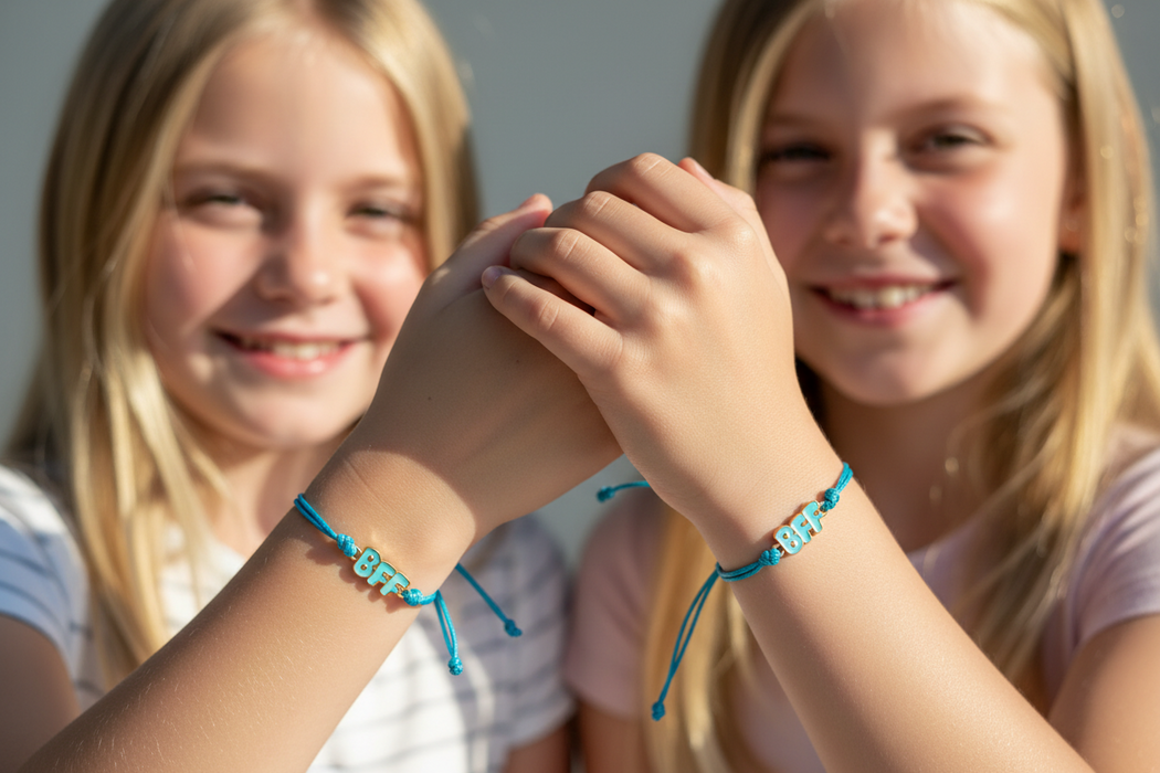 Image of 2 young girls wearing matching BFF bracelets
