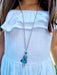 girl wearing silver scottish doll necklace