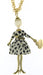 gold long chain necklace with doll pendant. Doll features spotted white dress, belt with heart, white head