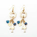 gold charm earrings with blue stone, blue ladybug charm and le carose doll charm